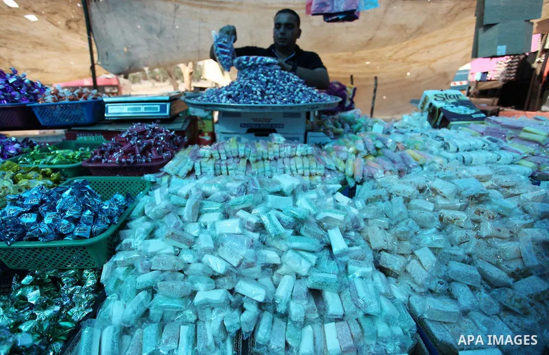 Palestinians shop at a market ahead of the Eid al-Fitr holiday, in Nuseirat refugee camp in the central Gaza Strip, on July 4, 2016. Eid al-Fitr marks the end of Muslim's holy fasting month of Ramadan when faithfuls abst...