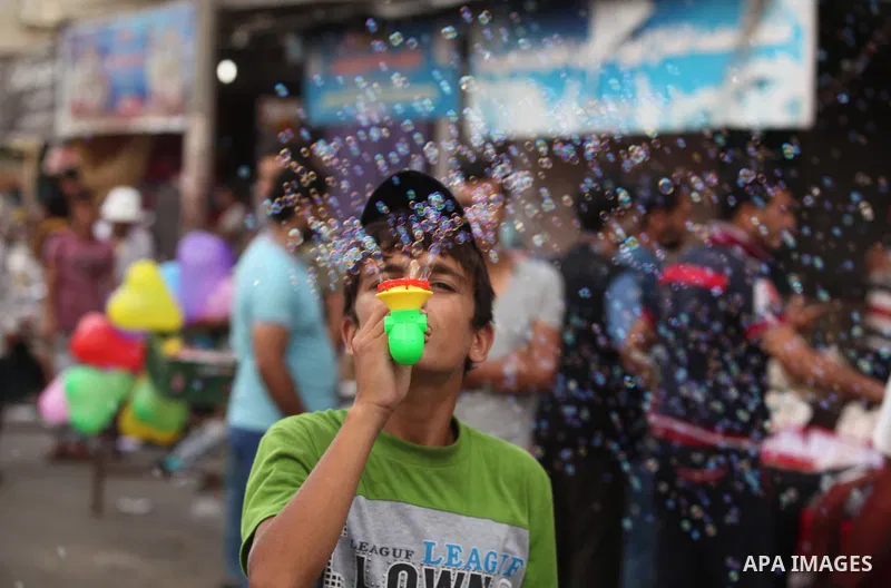 Palestinians shop at a market ahead of the Eid al-Fitr holiday, in Nuseirat refugee camp in the central Gaza Strip, on July 4, 2016. Eid al-Fitr marks the end of Muslim's holy fasting month of Ramadan when faithfuls abst...