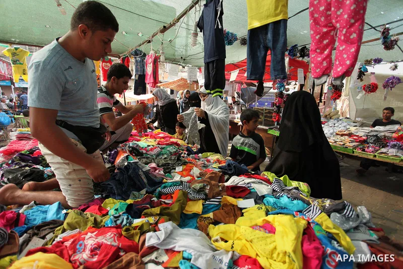 Palestinians shop at a market ahead of the Eid al-Fitr holiday, in Nuseirat refugee camp in the central Gaza Strip, on July 4, 2016. Eid al-Fitr marks the end of Muslim's holy fasting month of Ramadan when faithfuls abst...
