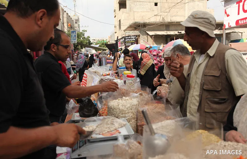 Palestinians shop at a market ahead of the Eid al-Fitr holiday, in Nuseirat refugee camp in the central Gaza Strip, on July 4, 2016. Eid al-Fitr marks the end of Muslim's holy fasting month of Ramadan when faithfuls abst...