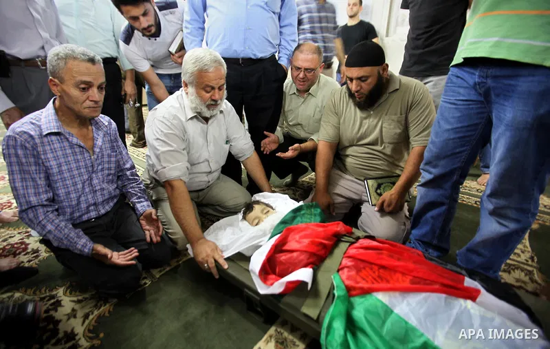 Mourners gather around the body of Rayyan Shreem"3 years", a Palestinian child who was killed in the Istanbul airport attack blamed on the Islamic State (IS) group on June 28, during his funeral in the West Bank town of...