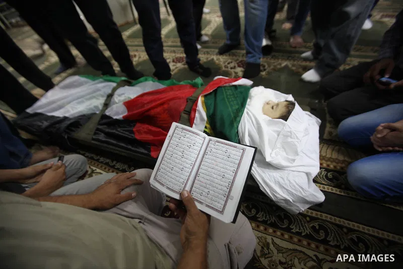 Mourners gather around the body of Rayyan Shreem"3 years", a Palestinian child who was killed in the Istanbul airport attack blamed on the Islamic State (IS) group on June 28, during his funeral in the West Bank town of...