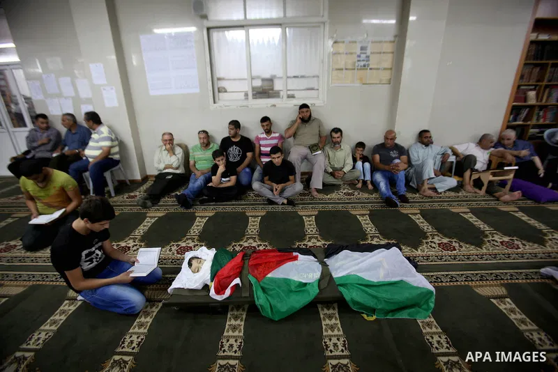 Mourners gather around the body of Rayyan Shreem"3 years", a Palestinian child who was killed in the Istanbul airport attack blamed on the Islamic State (IS) group on June 28, during his funeral in the West Bank town of...