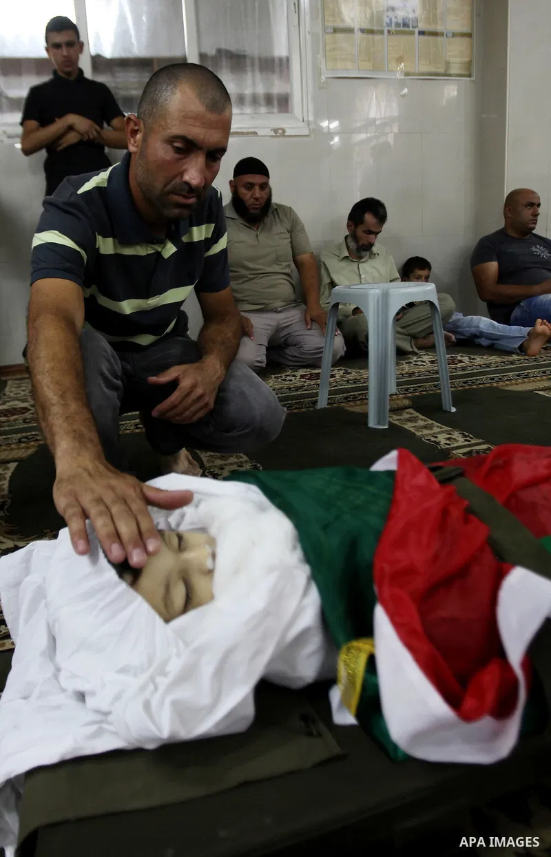 Mourners gather around the body of Rayyan Shreem"3 years", a Palestinian child who was killed in the Istanbul airport attack blamed on the Islamic State (IS) group on June 28, during his funeral in the West Bank town of...