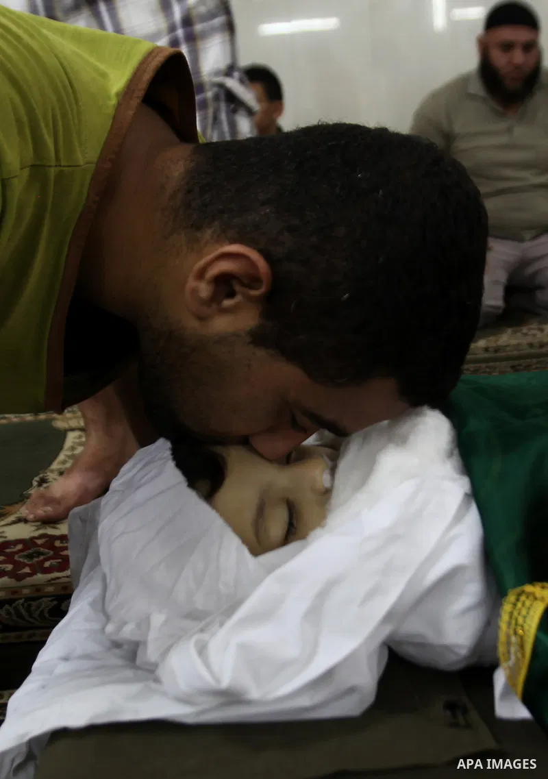 Mourners gather around the body of Rayyan Shreem"3 years", a Palestinian child who was killed in the Istanbul airport attack blamed on the Islamic State (IS) group on June 28, during his funeral in the West Bank town of...