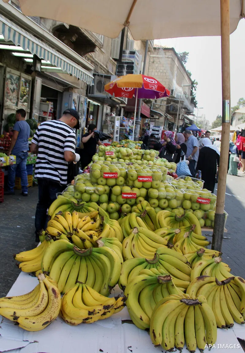 Palestinians shop at a market ahead of the Eid al-Fitr holiday, in Jerusalem old city, on July 3, 2016. Eid al-Fitr marks the end of Muslim's holy fasting month of Ramadan when faithfuls abstain from eating, drinking, sm...