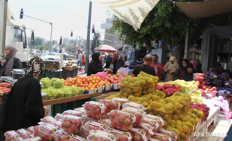Palestinians shop at a market ahead of the Eid al-Fitr holiday, in Jerusalem old city, on July 3, 2016. Eid al-Fitr marks the end of Muslim's holy fasting month of Ramadan when faithfuls abstain from eating, drinking, sm...