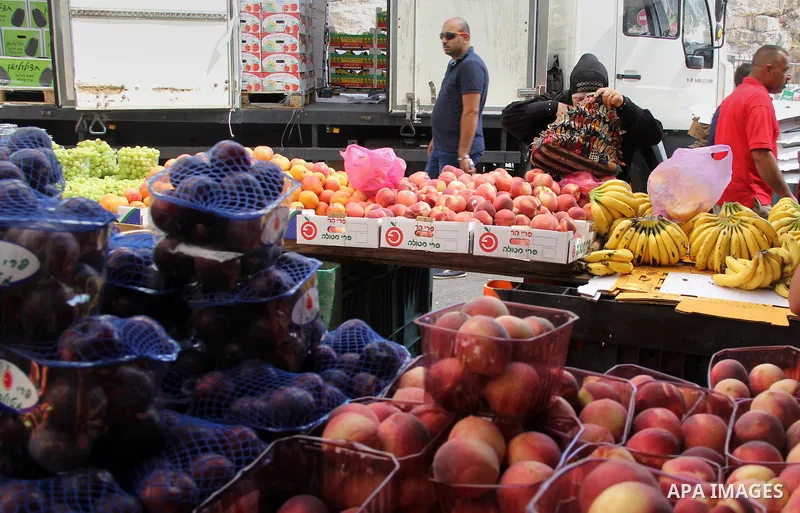 Palestinians shop at a market ahead of the Eid al-Fitr holiday, in Jerusalem old city, on July 3, 2016. Eid al-Fitr marks the end of Muslim's holy fasting month of Ramadan when faithfuls abstain from eating, drinking, sm...