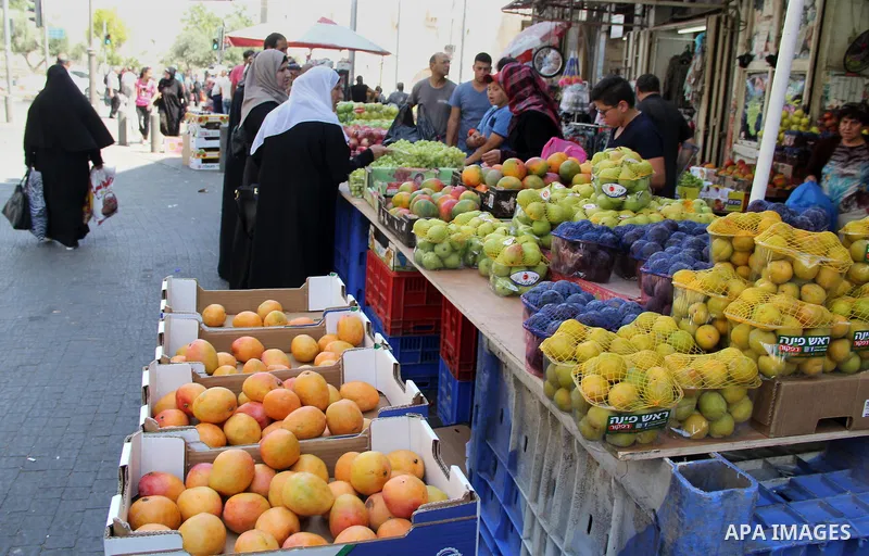 Palestinians shop at a market ahead of the Eid al-Fitr holiday, in Jerusalem old city, on July 3, 2016. Eid al-Fitr marks the end of Muslim's holy fasting month of Ramadan when faithfuls abstain from eating, drinking, sm...