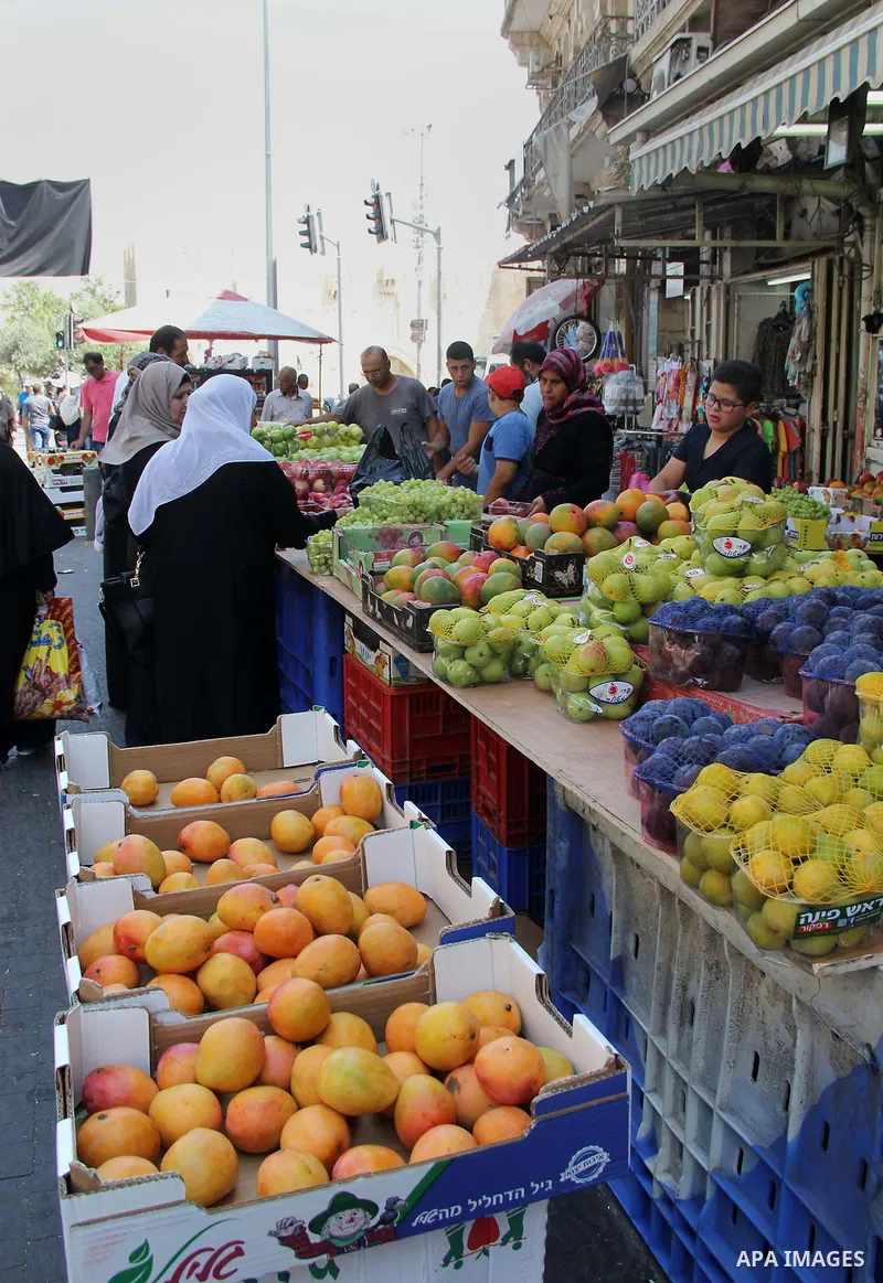 Palestinians shop at a market ahead of the Eid al-Fitr holiday, in Jerusalem old city, on July 3, 2016. Eid al-Fitr marks the end of Muslim's holy fasting month of Ramadan when faithfuls abstain from eating, drinking, sm...