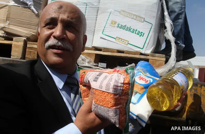 Undersecretary of the ministry of social affairs in Gaza, Yousef Ibrahim, shows contents of humanitarian aid parcels provided by Turkey to the press after it entered the southern Gaza Strip from Israel through the Kerem...