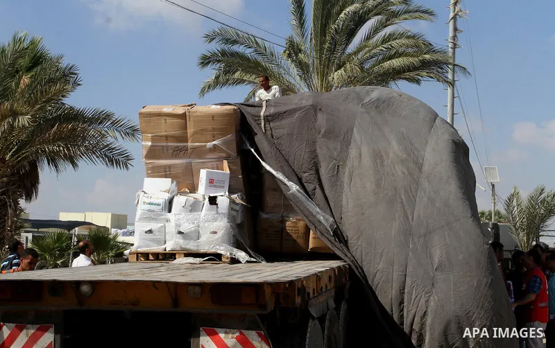Palestinians check Turkish aid shipments upon arrival in the Gaza Strip at Kerem Shalom crossing between Israel and southern Gaza Strip July 4, 2016. A Turkish ship carrying aid for Gaza arrived in Israel on July 3, a we...