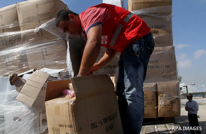 Palestinians check Turkish aid shipments upon arrival in the Gaza Strip at Kerem Shalom crossing between Israel and southern Gaza Strip July 4, 2016. A Turkish ship carrying aid for Gaza arrived in Israel on July 3, a we...