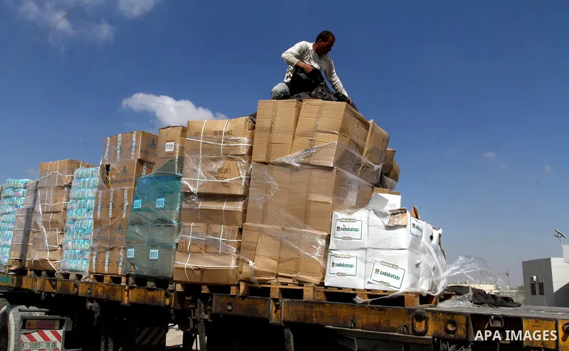 Palestinians check Turkish aid shipments upon arrival in the Gaza Strip at Kerem Shalom crossing between Israel and southern Gaza Strip July 4, 2016. A Turkish ship carrying aid for Gaza arrived in Israel on July 3, a we...
