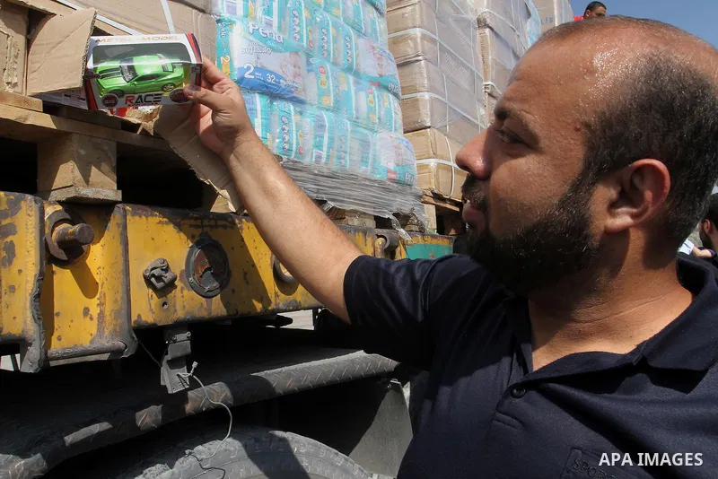 Palestinians check Turkish aid shipments upon arrival in the Gaza Strip at Kerem Shalom crossing between Israel and southern Gaza Strip July 4, 2016. A Turkish ship carrying aid for Gaza arrived in Israel on July 3, a we...