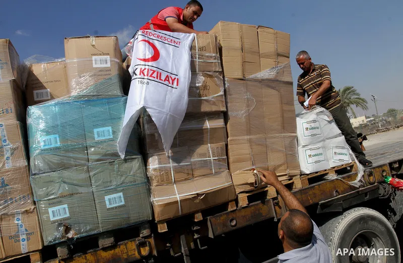 Palestinians check Turkish aid shipments upon arrival in the Gaza Strip at Kerem Shalom crossing between Israel and southern Gaza Strip July 4, 2016. A Turkish ship carrying aid for Gaza arrived in Israel on July 3, a we...