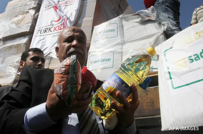 Undersecretary of the ministry of social affairs in Gaza, Yousef Ibrahim, shows contents of humanitarian aid parcels provided by Turkey to the press after it entered the southern Gaza Strip from Israel through the Kerem...