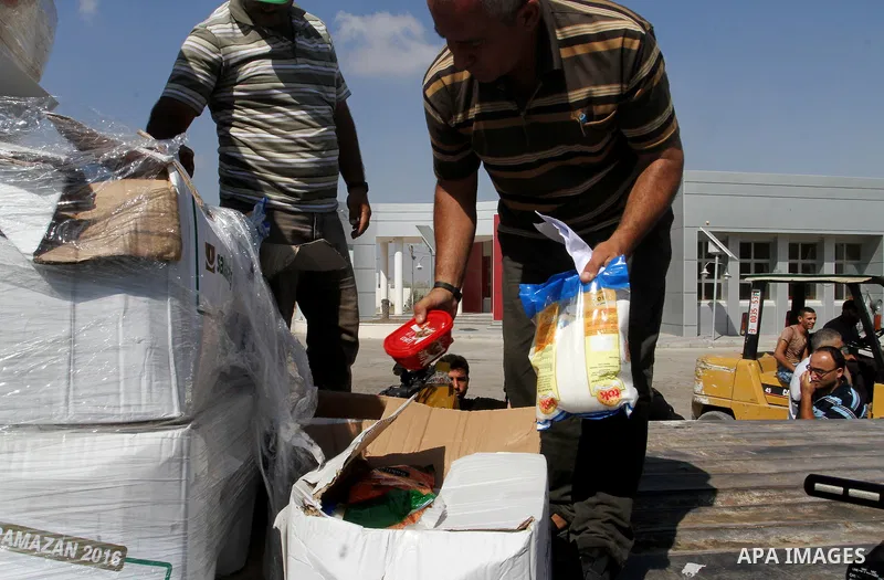 Palestinians check Turkish aid shipments upon arrival in the Gaza Strip at Kerem Shalom crossing between Israel and southern Gaza Strip July 4, 2016. A Turkish ship carrying aid for Gaza arrived in Israel on July 3, a we...
