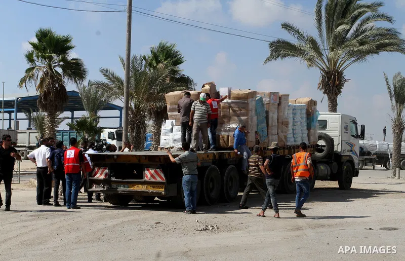 Palestinians check Turkish aid shipments upon arrival in the Gaza Strip at Kerem Shalom crossing between Israel and southern Gaza Strip July 4, 2016. A Turkish ship carrying aid for Gaza arrived in Israel on July 3, a we...