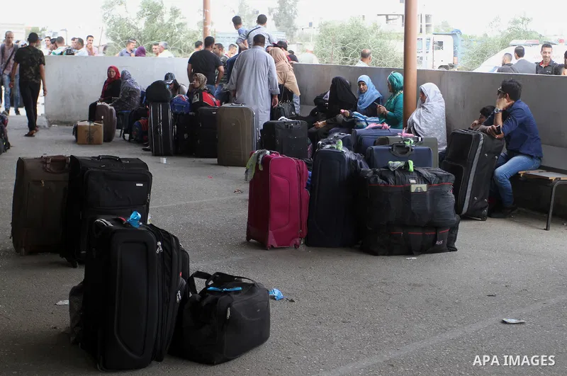 Palestinians wait for a travel permit to cross into Egypt through the Rafah border crossing after it was opened by Egyptian authorities for five days, in the southern Gaza Strip July 04, 2016. Photo by Abed Rahim Khatib