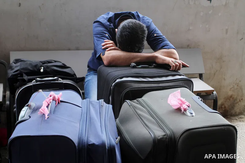Palestinians wait for a travel permit to cross into Egypt through the Rafah border crossing after it was opened by Egyptian authorities for five days, in the southern Gaza Strip July 04, 2016. Photo by Abed Rahim Khatib