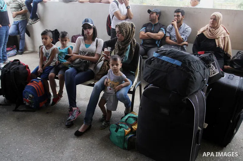 Palestinians wait for a travel permit to cross into Egypt through the Rafah border crossing after it was opened by Egyptian authorities for five days, in the southern Gaza Strip July 04, 2016. Photo by Abed Rahim Khatib