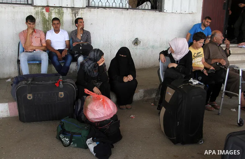 Palestinians wait for a travel permit to cross into Egypt through the Rafah border crossing after it was opened by Egyptian authorities for five days, in the southern Gaza Strip July 04, 2016. Photo by Abed Rahim Khatib