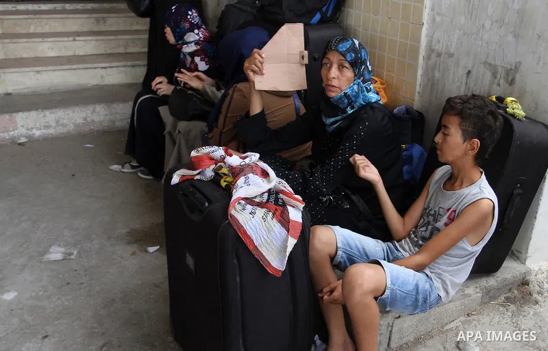 Palestinians wait for a travel permit to cross into Egypt through the Rafah border crossing after it was opened by Egyptian authorities for five days, in the southern Gaza Strip July 04, 2016. Photo by Abed Rahim Khatib