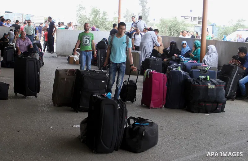 Palestinians wait for a travel permit to cross into Egypt through the Rafah border crossing after it was opened by Egyptian authorities for five days, in the southern Gaza Strip July 04, 2016. Photo by Abed Rahim Khatib