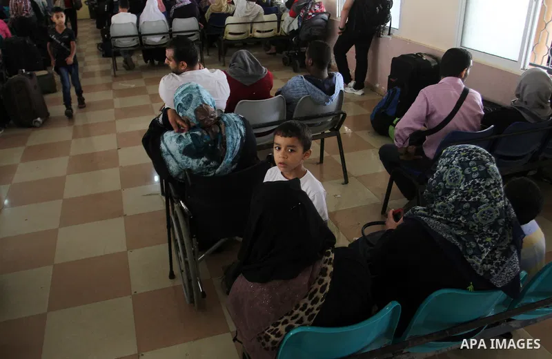 Palestinians wait for a travel permit to cross into Egypt through the Rafah border crossing after it was opened by Egyptian authorities for five days, in the southern Gaza Strip July 04, 2016. Photo by Abed Rahim Khatib