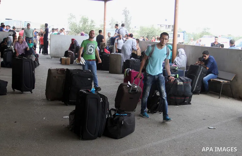 Palestinians wait for a travel permit to cross into Egypt through the Rafah border crossing after it was opened by Egyptian authorities for five days, in the southern Gaza Strip July 04, 2016. Photo by Abed Rahim Khatib