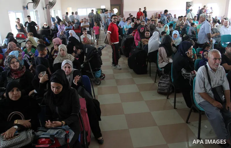 Palestinians wait for a travel permit to cross into Egypt through the Rafah border crossing after it was opened by Egyptian authorities for five days, in the southern Gaza Strip July 04, 2016. Photo by Abed Rahim Khatib