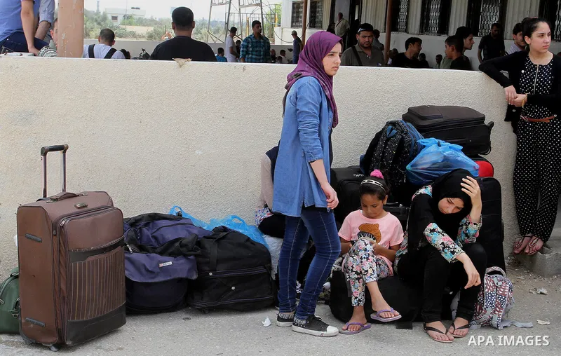 Palestinians wait for a travel permit to cross into Egypt through the Rafah border crossing after it was opened by Egyptian authorities for five days, in the southern Gaza Strip July 04, 2016. Photo by Abed Rahim Khatib