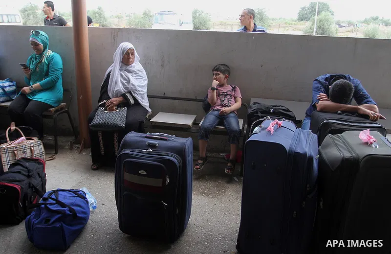 Palestinians wait for a travel permit to cross into Egypt through the Rafah border crossing after it was opened by Egyptian authorities for five days, in the southern Gaza Strip July 04, 2016. Photo by Abed Rahim Khatib