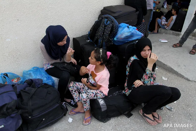 Palestinians wait for a travel permit to cross into Egypt through the Rafah border crossing after it was opened by Egyptian authorities for five days, in the southern Gaza Strip July 04, 2016. Photo by Abed Rahim Khatib