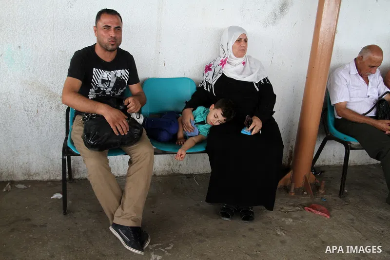 Palestinians wait for a travel permit to cross into Egypt through the Rafah border crossing after it was opened by Egyptian authorities for five days, in the southern Gaza Strip July 04, 2016. Photo by Abed Rahim Khatib
