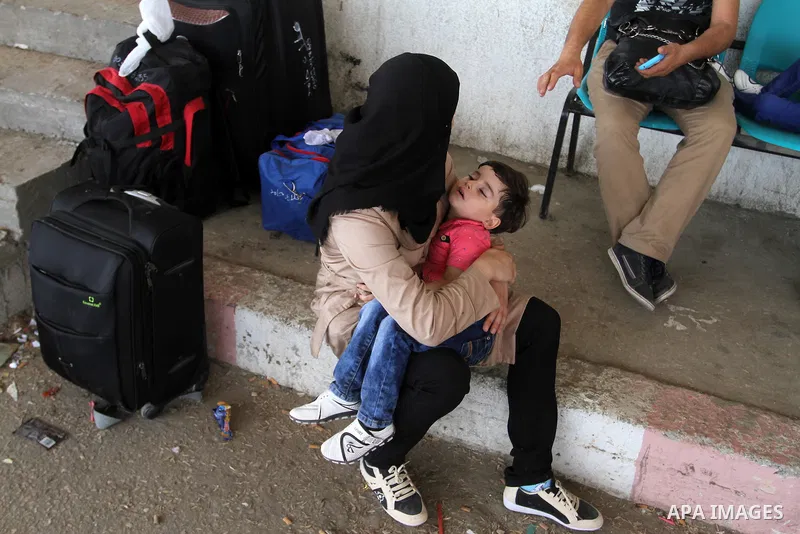 Palestinians wait for a travel permit to cross into Egypt through the Rafah border crossing after it was opened by Egyptian authorities for five days, in the southern Gaza Strip July 04, 2016. Photo by Abed Rahim Khatib
