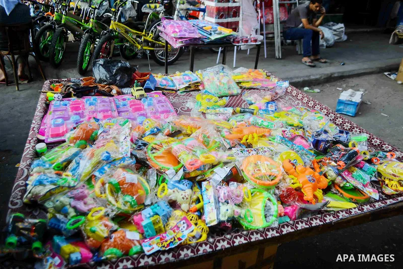 Egyptians shop at market ahead of the Eid al-Fitr holiday in Cairo, Egypt, on July 04, 2016, as Muslims the world over prepare to celebrate Eid al-Fitr, starting with the with the sighting of the new moon, to mark the en...