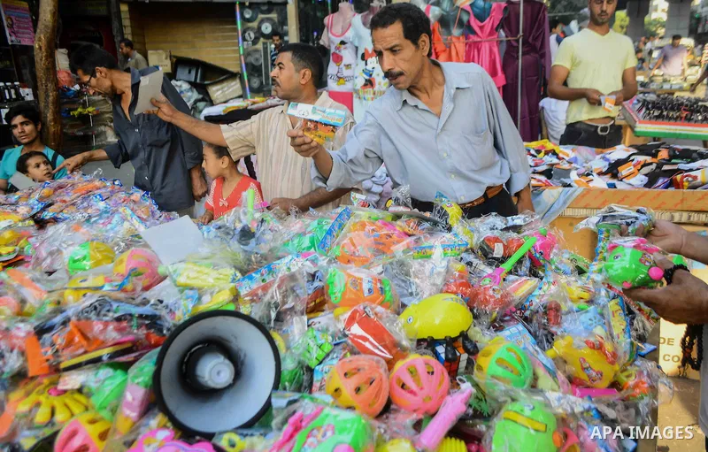 Egyptians shop at market ahead of the Eid al-Fitr holiday in Cairo, Egypt, on July 04, 2016, as Muslims the world over prepare to celebrate Eid al-Fitr, starting with the with the sighting of the new moon, to mark the en...
