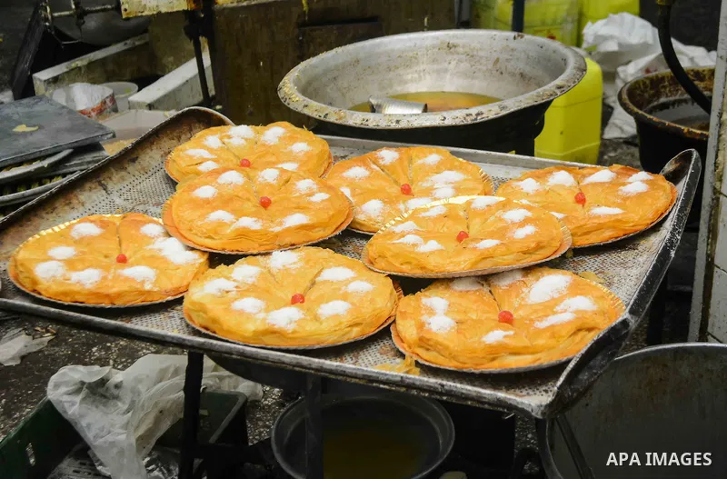 Egyptian bakers prepare date-filled mini cakes traditional for the Eid al-Fitr a three-day holiday that marks the end of the fasting month of Ramadan, at shop in Cairo, Egypt, on July 4, 2016, as Muslims the world over p...