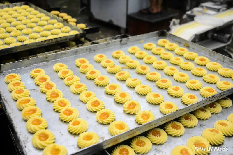 Egyptian bakers prepare date-filled mini cakes traditional for the Eid al-Fitr a three-day holiday that marks the end of the fasting month of Ramadan, at shop in Cairo, Egypt, on July 4, 2016, as Muslims the world over p...
