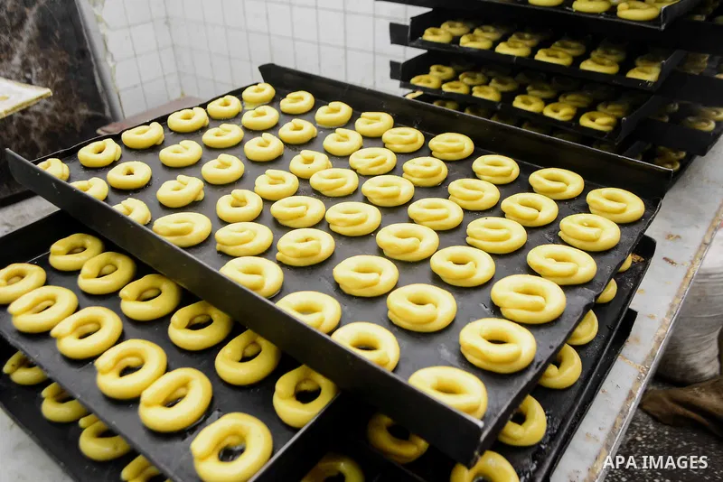 Egyptian bakers prepare date-filled mini cakes traditional for the Eid al-Fitr a three-day holiday that marks the end of the fasting month of Ramadan, at shop in Cairo, Egypt, on July 4, 2016, as Muslims the world over p...