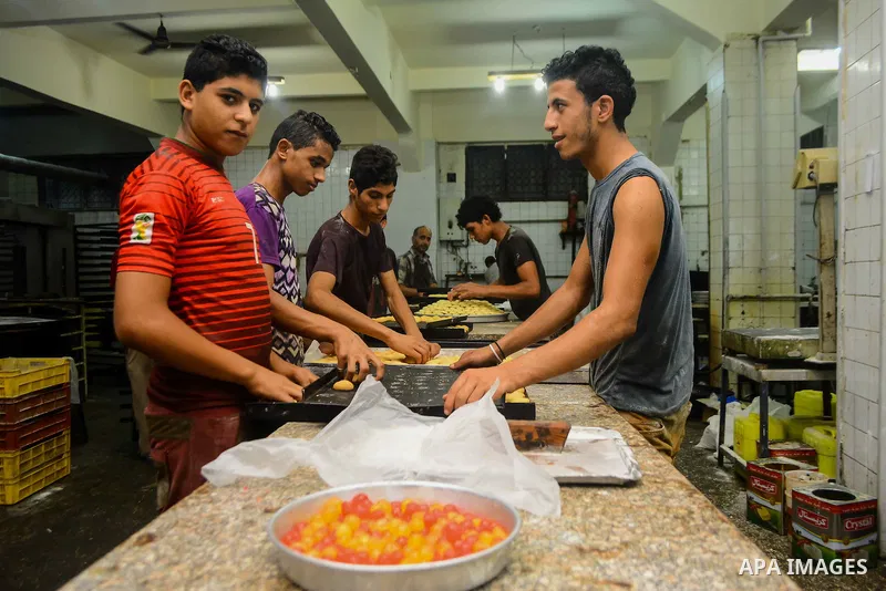 Egyptian bakers prepare date-filled mini cakes traditional for the Eid al-Fitr a three-day holiday that marks the end of the fasting month of Ramadan, at shop in Cairo, Egypt, on July 4, 2016, as Muslims the world over p...
