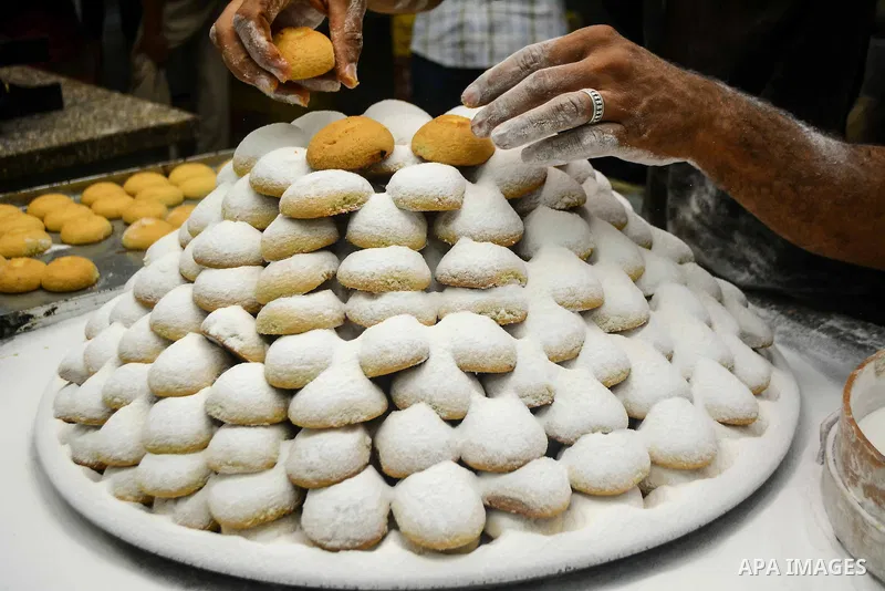 Egyptian bakers prepare date-filled mini cakes traditional for the Eid al-Fitr a three-day holiday that marks the end of the fasting month of Ramadan, at shop in Cairo, Egypt, on July 4, 2016, as Muslims the world over p...