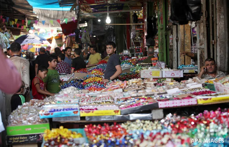 Palestinians shop at market ahead of the Eid al-Fitr holiday in Gaza city, on July 05, 2016, as Muslims the world over prepare to celebrate Eid al-Fitr, starting with the with the sighting of the new moon, to mark the en...