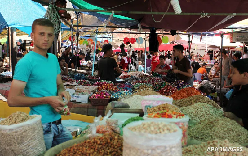 Palestinians shop at market ahead of the Eid al-Fitr holiday in Gaza city, on July 05, 2016, as Muslims the world over prepare to celebrate Eid al-Fitr, starting with the with the sighting of the new moon, to mark the en...