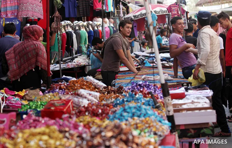 Palestinians shop at market ahead of the Eid al-Fitr holiday in Gaza city, on July 05, 2016, as Muslims the world over prepare to celebrate Eid al-Fitr, starting with the with the sighting of the new moon, to mark the en...