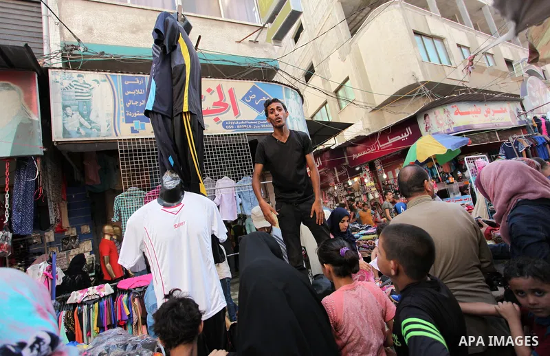Palestinians shop at market ahead of the Eid al-Fitr holiday in Gaza city, on July 05, 2016, as Muslims the world over prepare to celebrate Eid al-Fitr, starting with the with the sighting of the new moon, to mark the en...