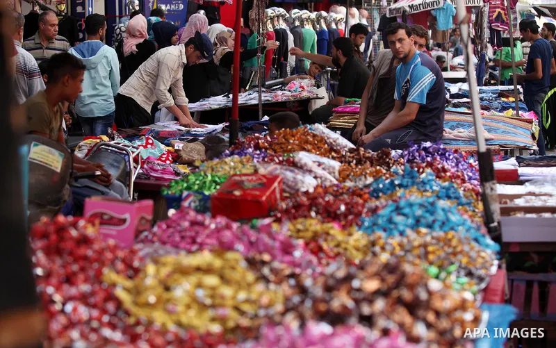 Palestinians shop at market ahead of the Eid al-Fitr holiday in Gaza city, on July 05, 2016, as Muslims the world over prepare to celebrate Eid al-Fitr, starting with the with the sighting of the new moon, to mark the en...