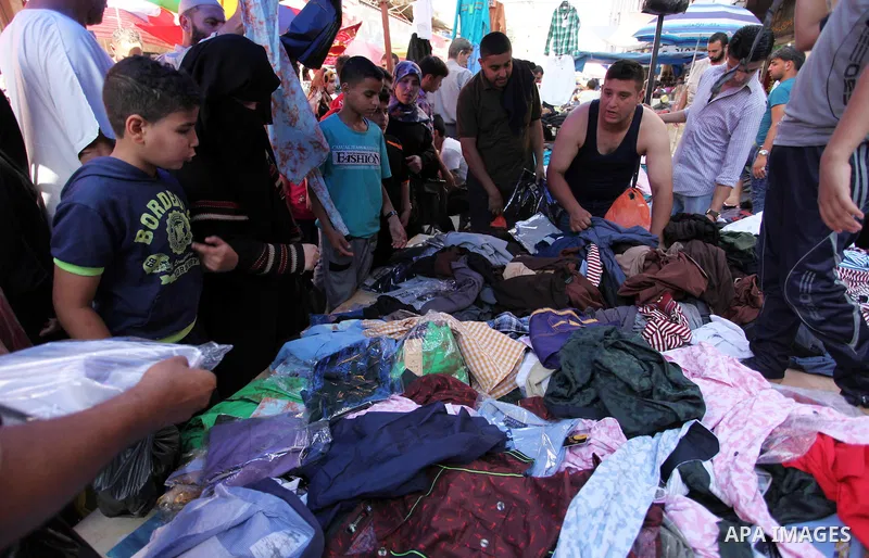 Palestinians shop at market ahead of the Eid al-Fitr holiday in Gaza city, on July 05, 2016, as Muslims the world over prepare to celebrate Eid al-Fitr, starting with the with the sighting of the new moon, to mark the en...